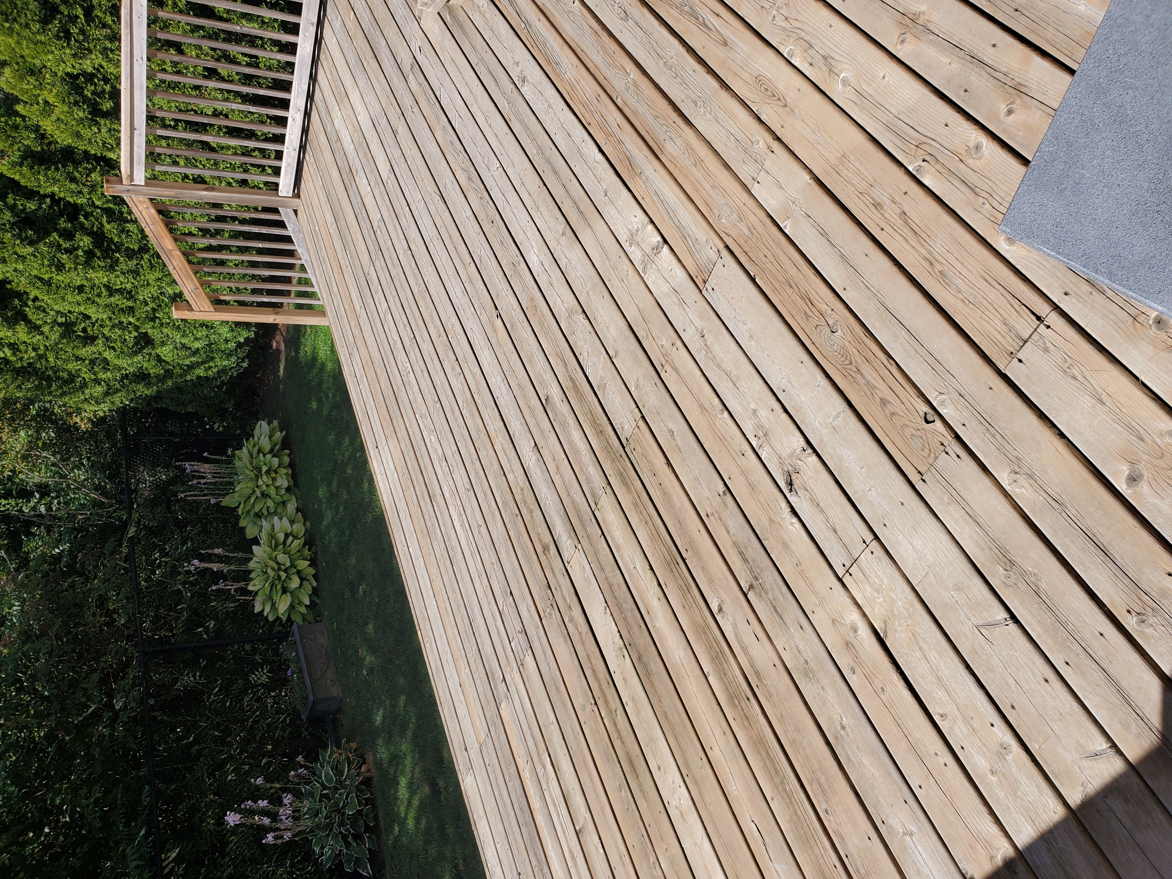 Deck before — pressure washed bare grey boards