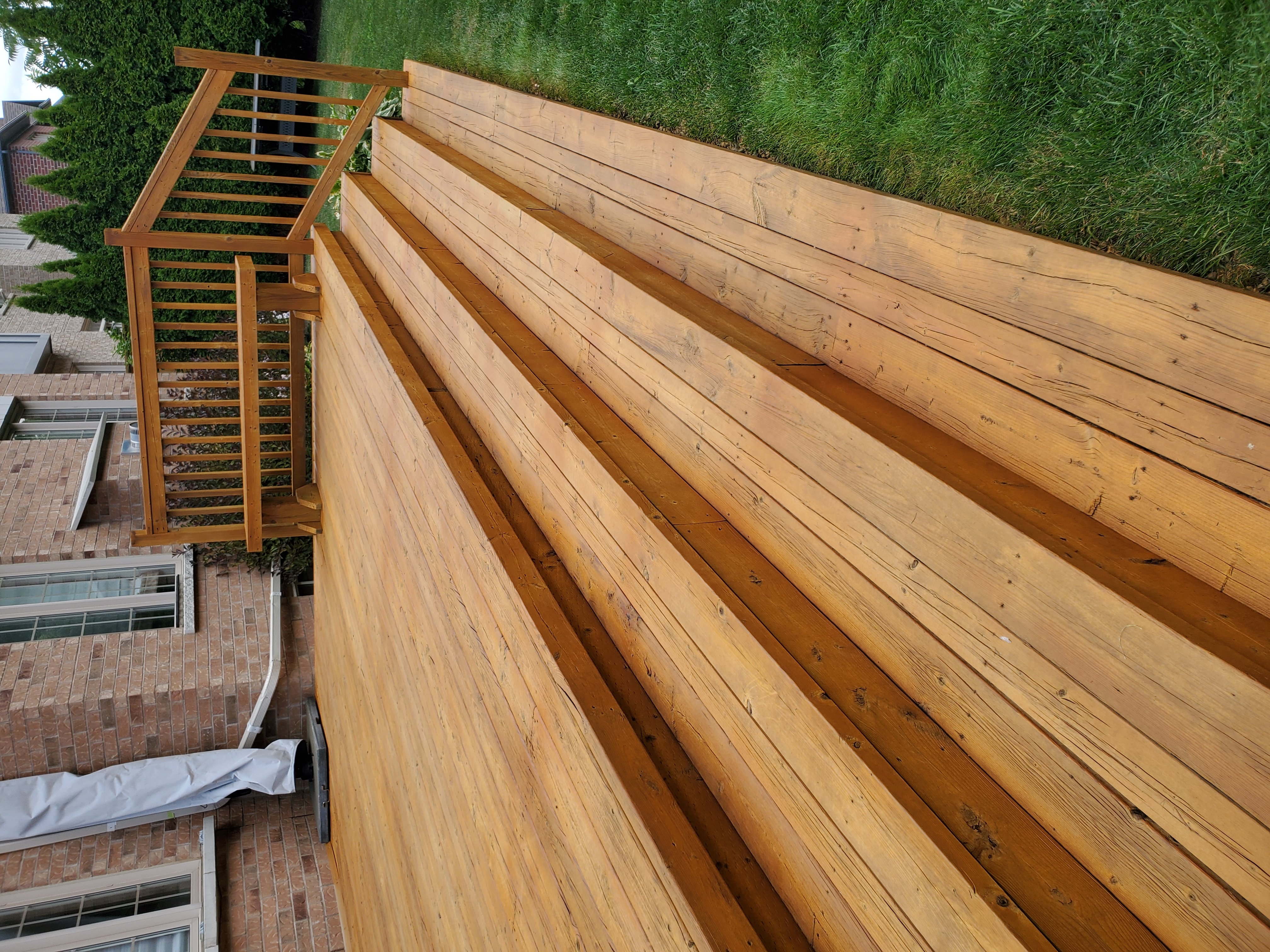 Freshly stained deck with wide stairs — honey gold tone