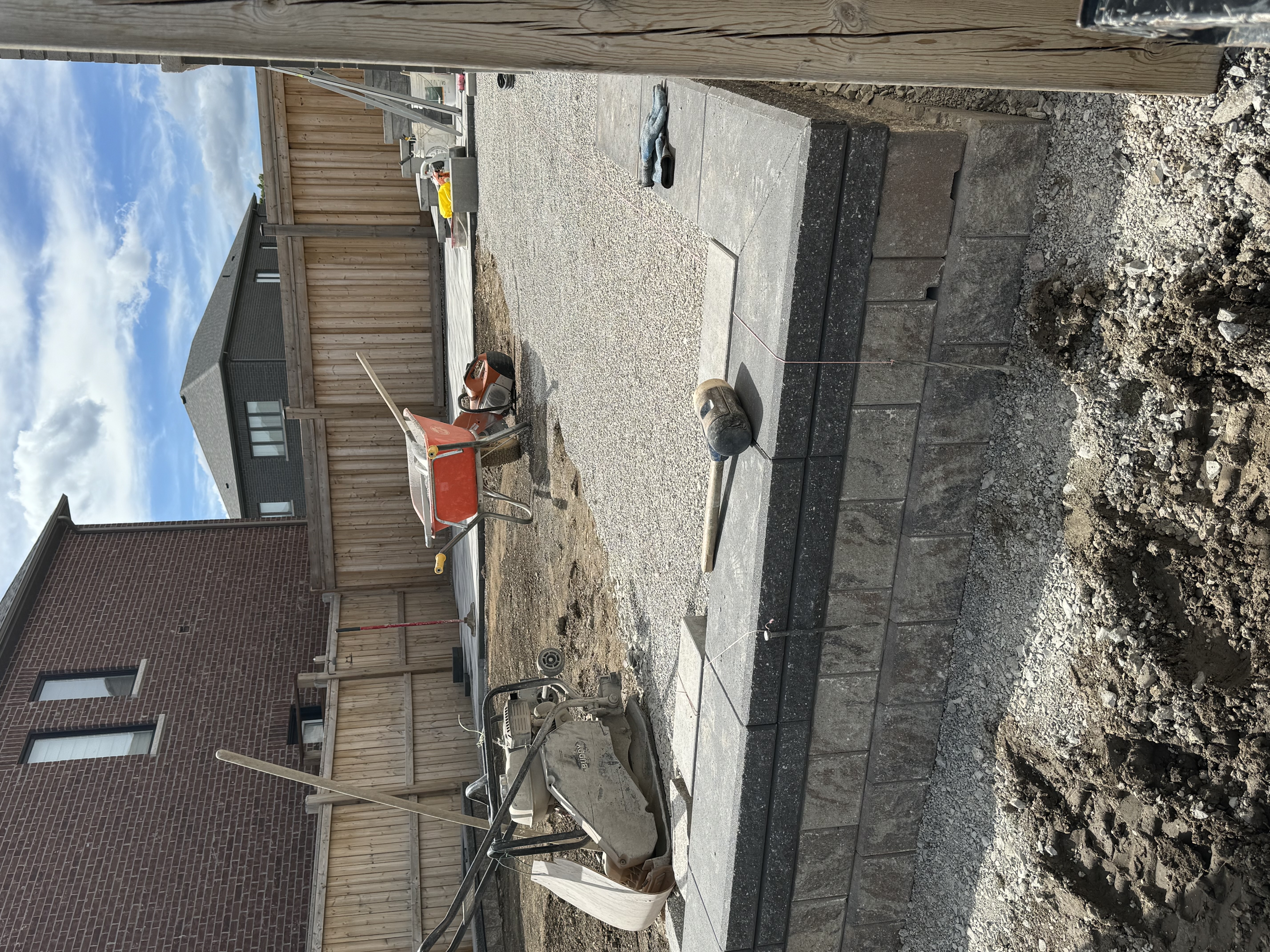 Backyard interlock in progress — retaining wall and gravel base