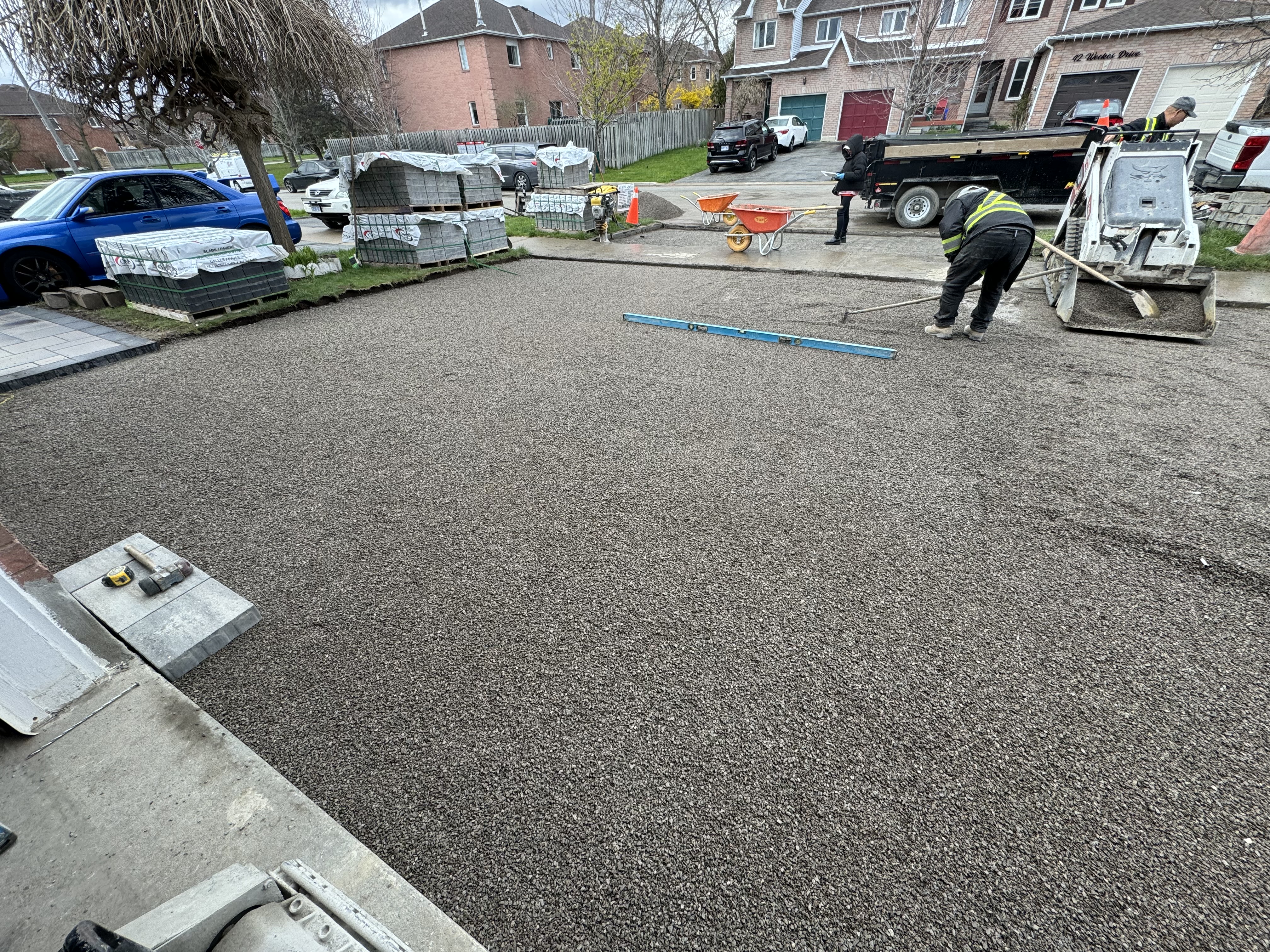 Crew leveling granular A base for interlock driveway