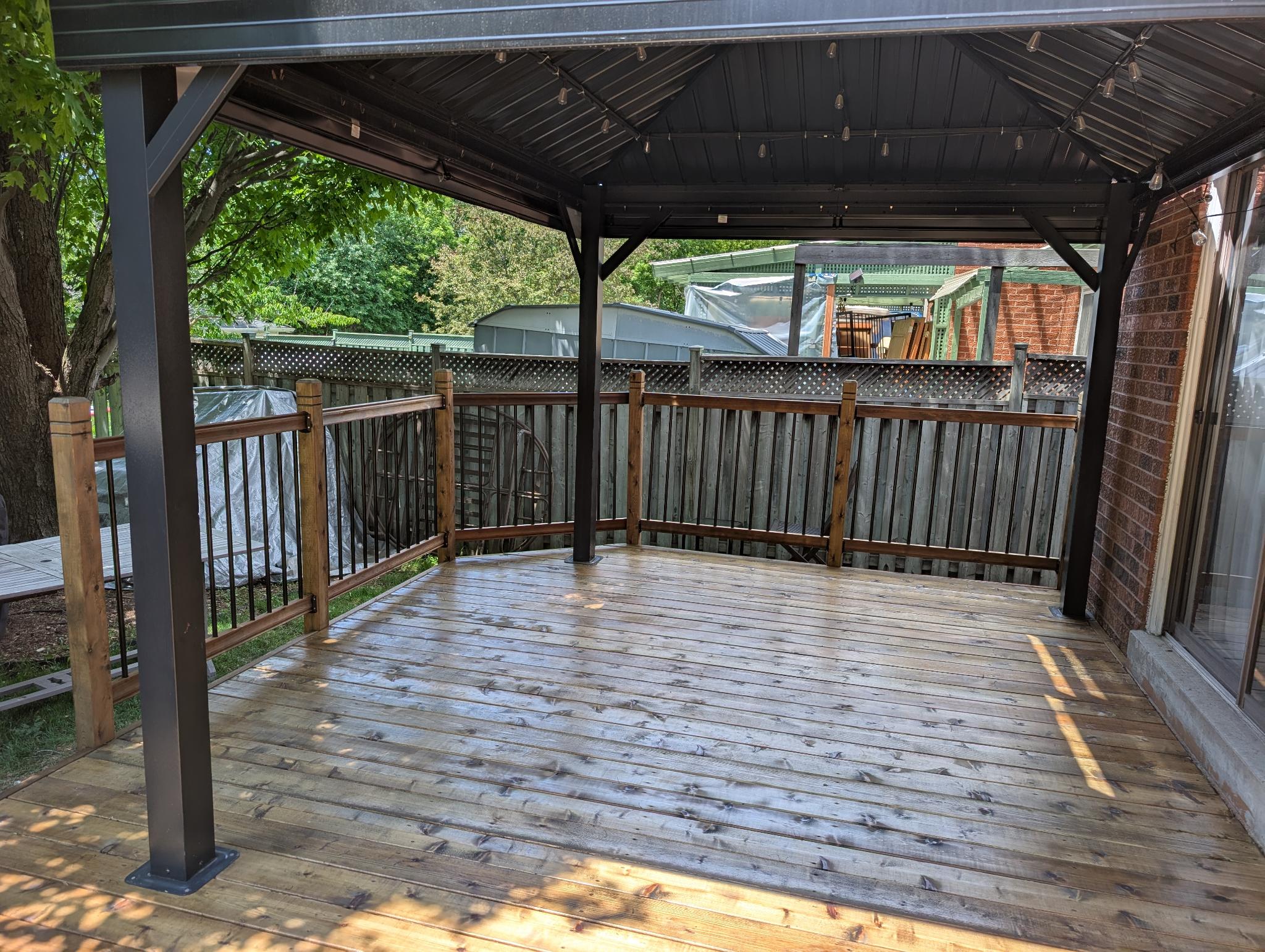 Gazebo deck before staining — fresh unstained boards